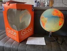 Illuminated World Globe on stand. Showing countries, rivers, mountain ranges.