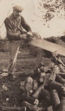 1920s Man Large Long Saw Sawing Wood Pile Labor Rustic Scene Lumber Firewood