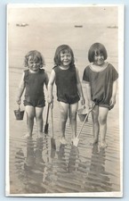 POSTCARD 3 CHILDREN PADDLING IN THE SEA BUCKETS AND SPADES - RPPC SEASIDE PHOTO