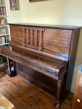 Upright piano - cross-strung with iron frame. This type of piano keeps in tune.