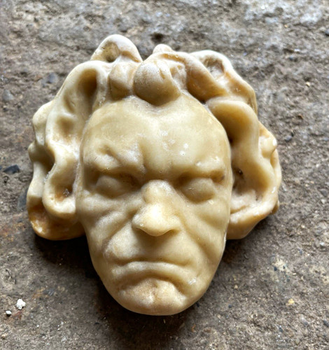 Carved face ornament