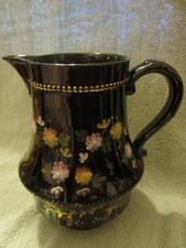 Geisha Jackfield style black jug with floral design.  Rgd no. 80584 (date 1887)