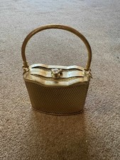 SMALL GOLD COLOURED HANDBAG WITH CARRY HANDLE SOLID WITH SMALL BRACELET  INSIDE 