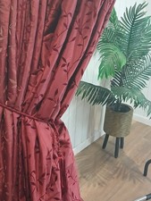 Deep claret red curtains with an embossed velvet leaf design