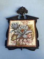 ANTIQUE EDWARDIAN CERAMIC TILED IN LATER CAST IRON FRAMED TRIVET MARKED "JAPAN"