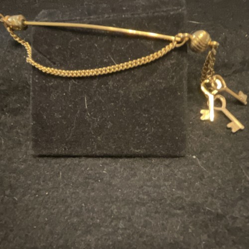 Gold tone metal stick - tone,