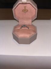 One palladium ring with 14 diamonds , Emmy size Q, 0.33, is very good