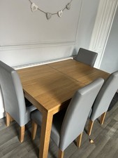 Wooden Table And Four Grey Chairs