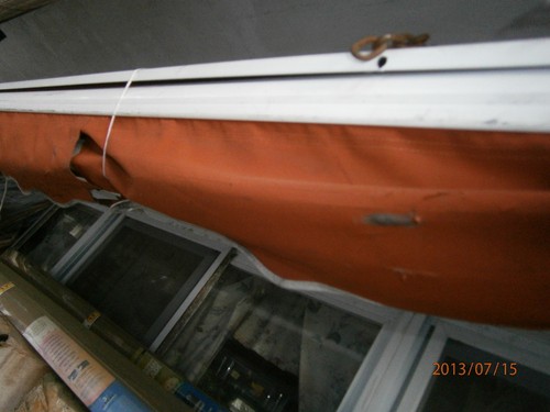 Red fabric awning - ,, damaged