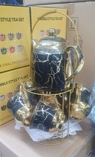 Teapot With Cups And Saucers