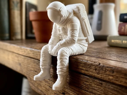 Astronaut sitting edge - sitting,