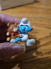 Smurf Baby Holding Teddy Bear