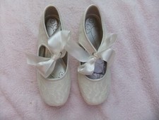 Girls Ivory lace look  shoes with tie bows and small heel size 11.