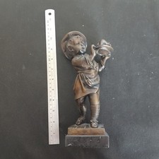 Bronze Chef stature holding a cooked chicken on plinth 