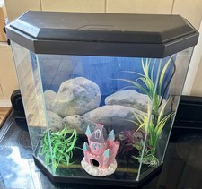 Fish Tank with LED Lights, black surround with castle and ornamental plants. 