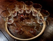 A tray and matching glasses of foxhunting interest, huntsman hounds and the fox.