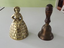 Hand Bells  2 unmatched  1 is brass of a lady the other a wooden handle