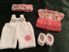 Hand knitted dolls clothes to