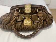 Amazing brown miu miu bag with gold clasp and detail. Very spacey inside. 