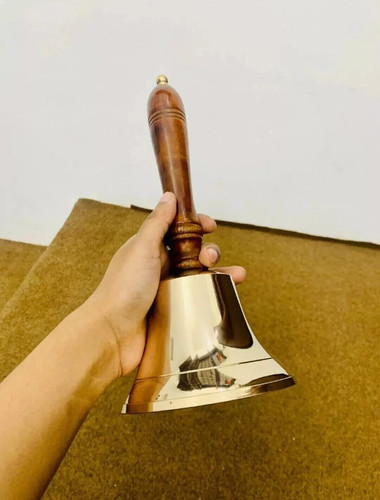 Brass hand held bell - hand,
