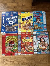 6 cereal boxes  - Oreo Os, Nesquik, Powerpuff Girls, Jurassic, Monopoly, Pebbles