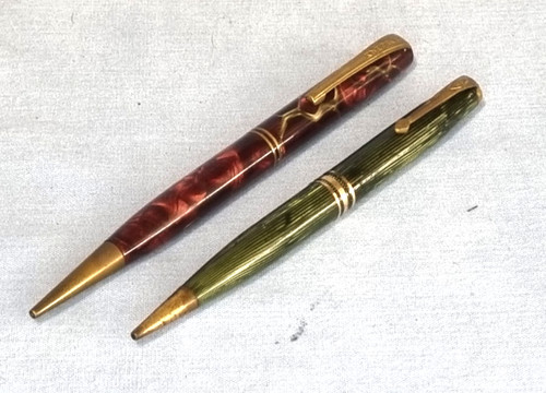Two antique propelling - , pencils