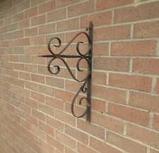 Vintage weathered rusty wrought iron style decorative garden wall bracket 
