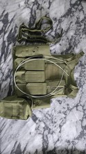 Army Green Airsoft Vest With Various Pouches And A Rifle Sling