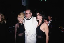 Drew Carey poses two women at