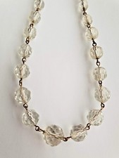 Vintage clear faceted graduated crystal gold tone rosary linked necklace.