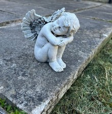 Angel boy sleeping garden