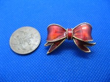 VINTAGE SIGNED SPHINX ENAMELLED RED ENAMEL RIBBON BOW BROOCH.