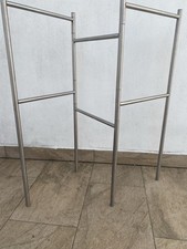 IKEA Metalic Towel Rack With Three Sections And Six Horizontal Bars.