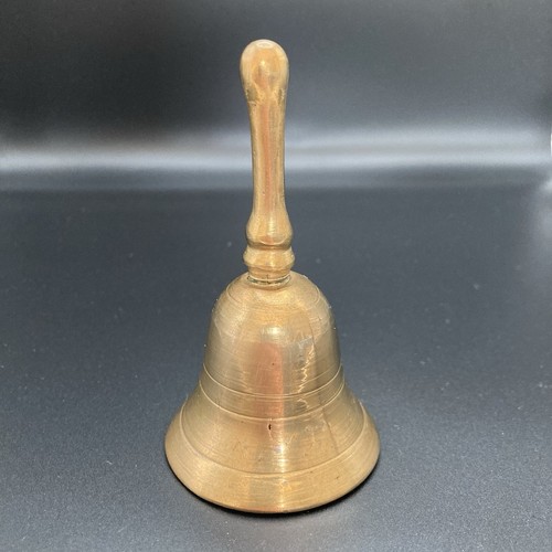 Vintage brass hand held bell - hand,