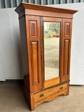 A Victorian walnut mirror door wardrobe