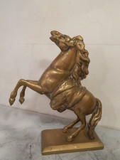 An antique brass horse ornament