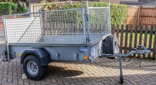 Ifor Williams caged trailer P6E with cover, hitch lock, and wheel lock.