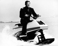 Roger Moore as Bond rides