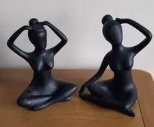 Pair Of Black Figurines In Yoga Poses