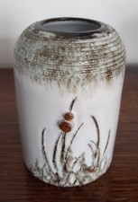 Pottery vase. White glaze with raised thistle pattern.
