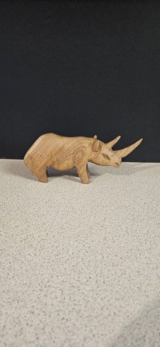 Hand carved wooden rhino - hand,