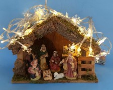 Medium Size Ceramic Nativity Set,  Wooden Stable with Snowflake Lights batty inc