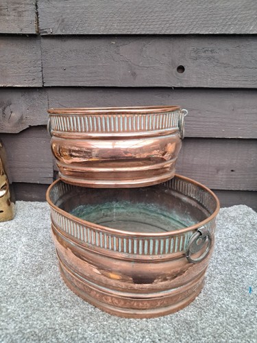 Two vintage oval copper plant