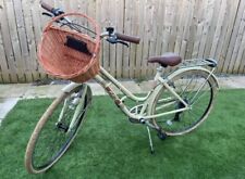 Women’s cream bike with wicker basket