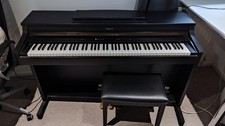 Roland HP103e Digital Piano in good condition with matching stool