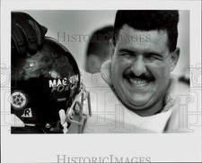 1994 Press Photo Man Smiles with Magnum Force Football Helmet, Pig Bowl Practice