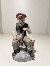 Old Man Sitting Down Holding
