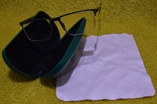 Porsche Design glasses frame with Specsavers green case and cleaning cloth