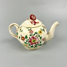 A diminutive Leeds Pottery creamware teapot c.1775 with crossover handles