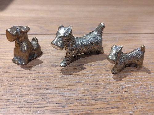 Three brass dog ornaments - three,